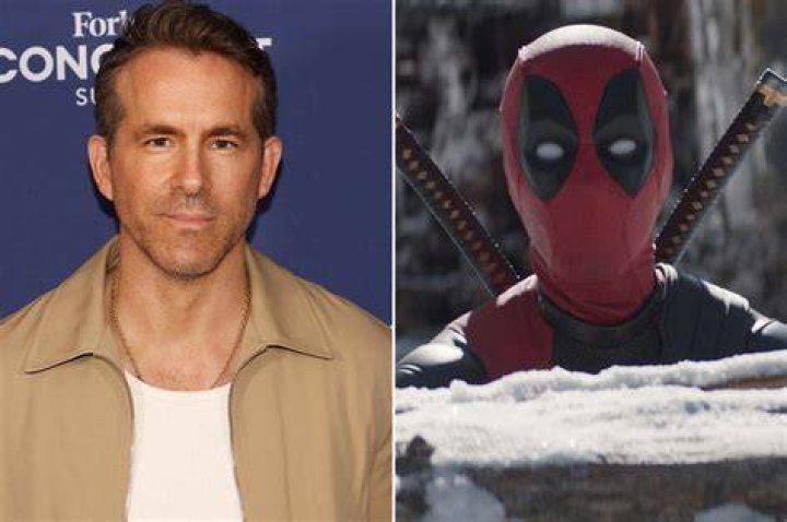 Ryan Reynolds as Deadpool, covering his masked mouth in a shocked expression